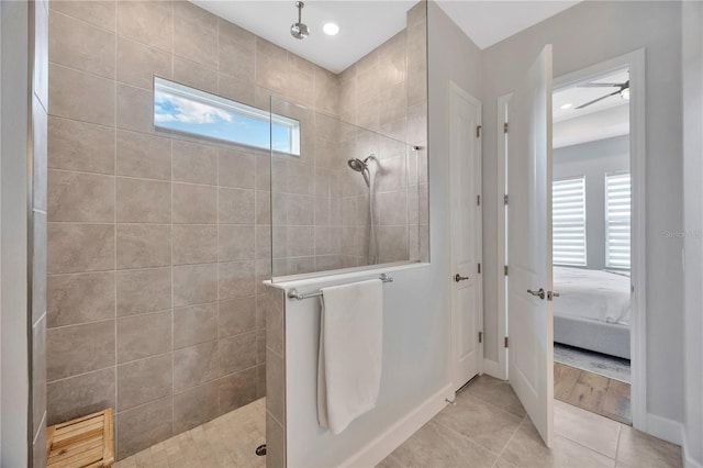 bathroom with a tile shower, a wealth of natural light, and tile patterned floors