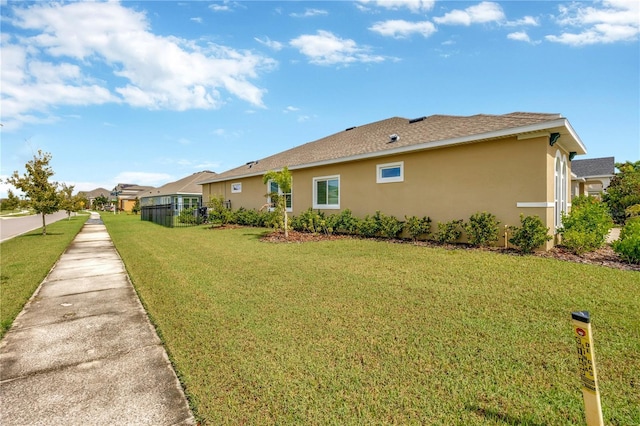 view of side of property with a yard