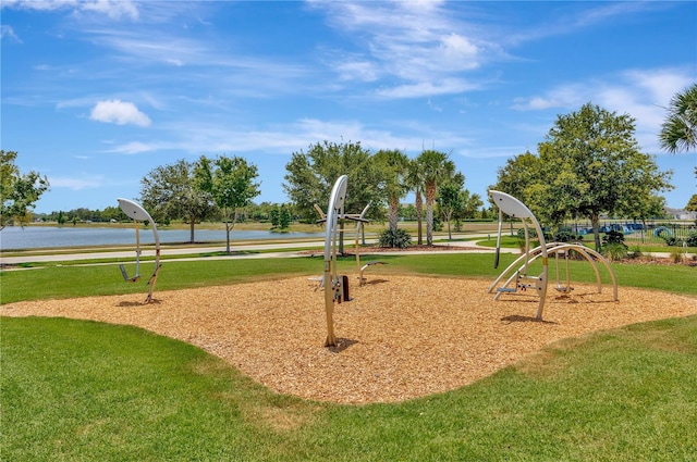 surrounding community featuring a playground, a water view, and a yard