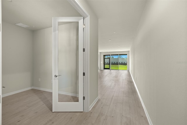 corridor with light hardwood / wood-style floors