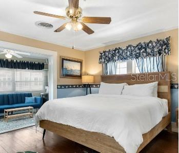 bedroom featuring dark wood-type flooring and ceiling fan