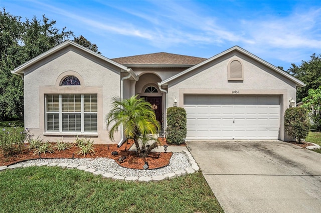 ranch-style house with a garage and a front lawn