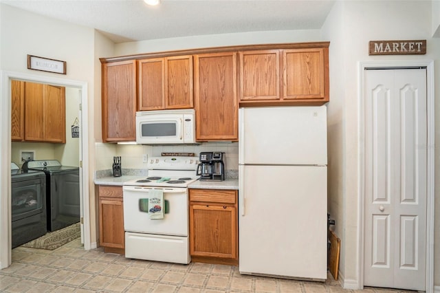 kitchen with washing machine and dryer and white appliances