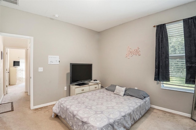 bedroom featuring light carpet