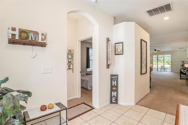 hall featuring light colored carpet