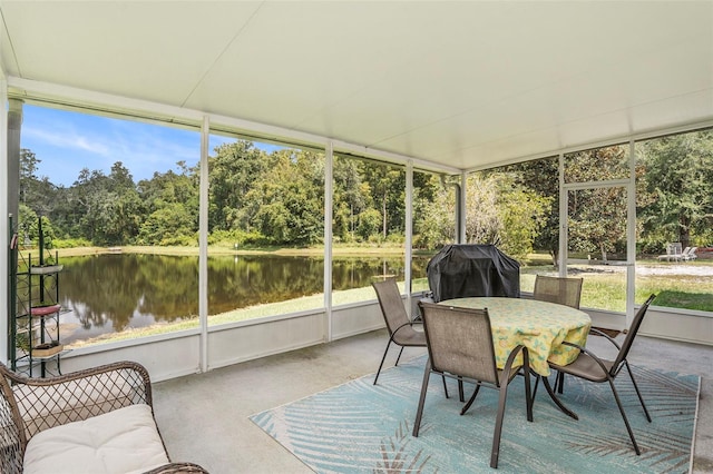 sunroom / solarium with a water view and a healthy amount of sunlight