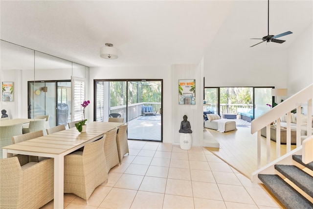 kitchen with light tile patterned floors, a towering ceiling, and ceiling fan