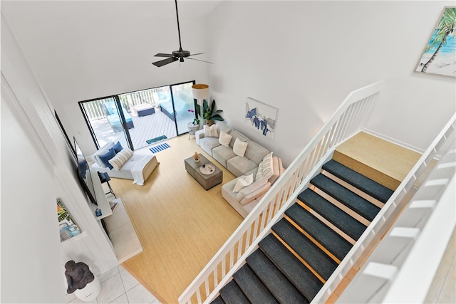 tiled living room featuring a high ceiling and ceiling fan