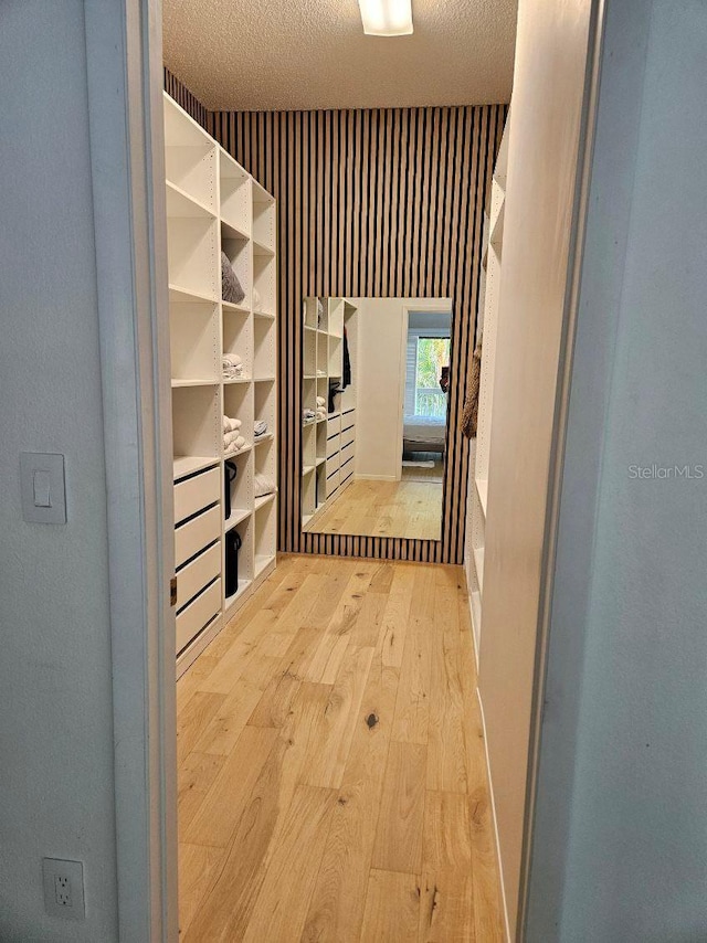 interior space with a textured ceiling and light hardwood / wood-style flooring