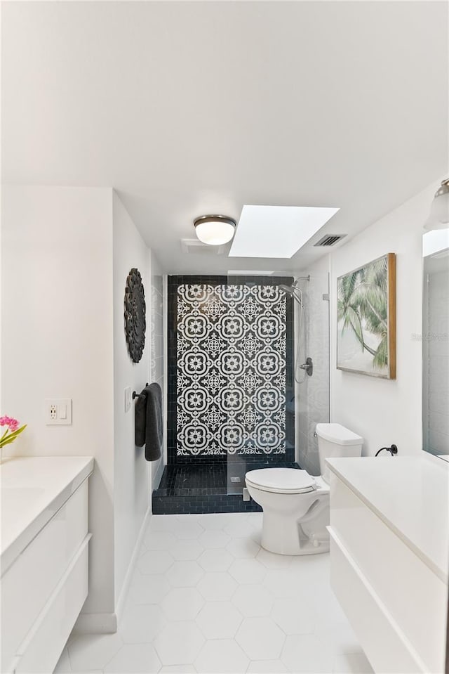 bathroom with a skylight, visible vents, toilet, a shower stall, and vanity