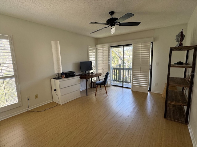 office space featuring a textured ceiling, hardwood / wood-style flooring, and a wealth of natural light