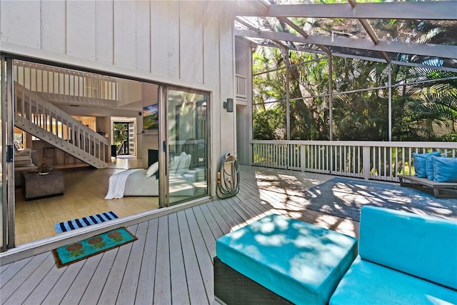 deck with a lanai, an outdoor hangout area, and stairs