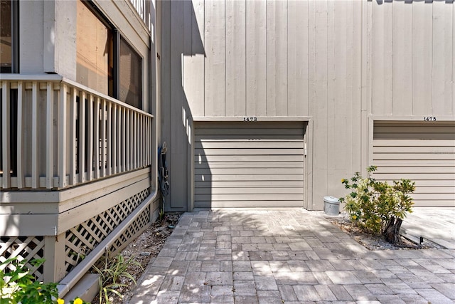 view of home's exterior with a garage and decorative driveway