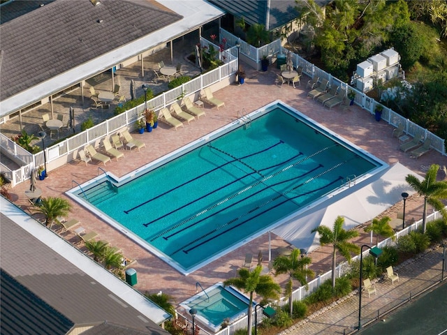 pool with a patio area and fence