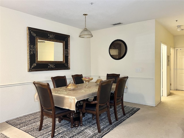 dining area featuring light colored carpet