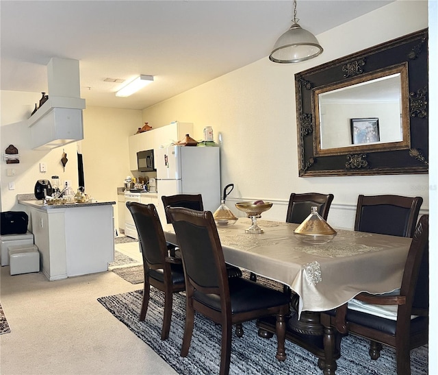 view of carpeted dining area