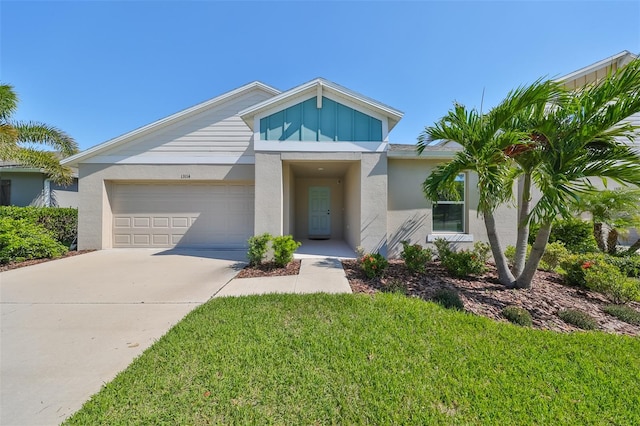 view of front of home featuring a front lawn and a garage