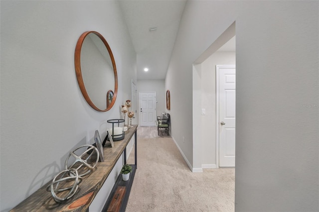 corridor featuring light colored carpet