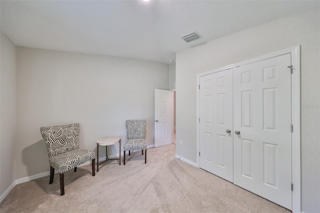 living area featuring light colored carpet