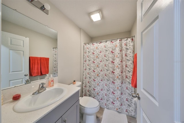 bathroom with vanity, a shower with curtain, and toilet