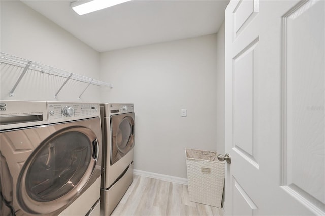 washroom featuring light hardwood / wood-style flooring and washing machine and dryer