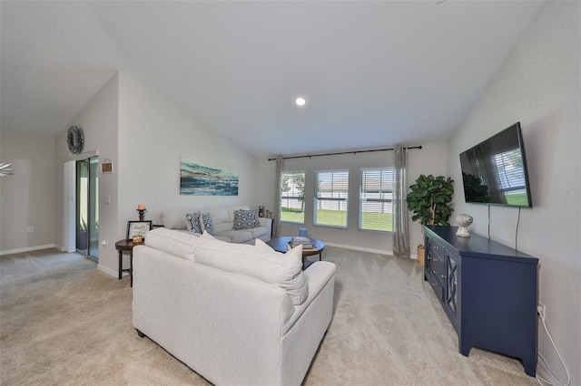 carpeted living room featuring lofted ceiling