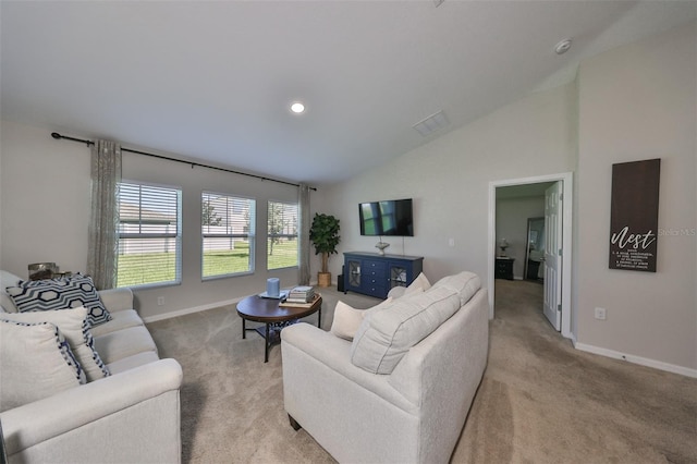 carpeted living room featuring high vaulted ceiling