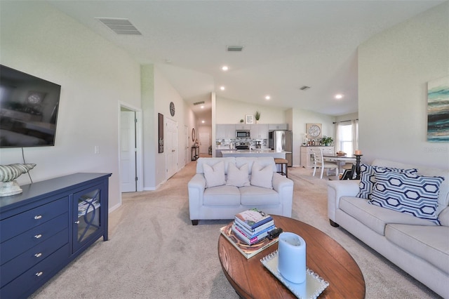 living room with light carpet and vaulted ceiling