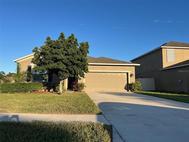 view of front of property with a garage and a front lawn