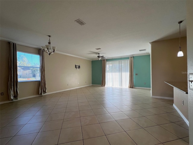 tiled spare room with ceiling fan with notable chandelier and ornamental molding