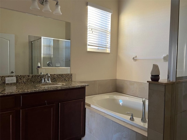 bathroom featuring vanity and independent shower and bath