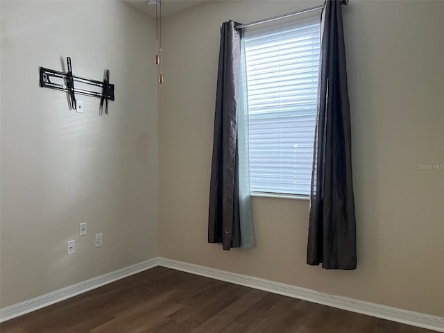 unfurnished room featuring dark hardwood / wood-style floors