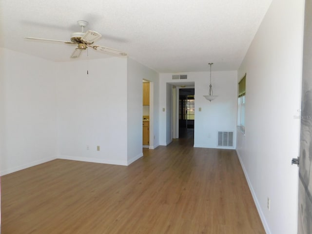 spare room with hardwood / wood-style flooring and ceiling fan