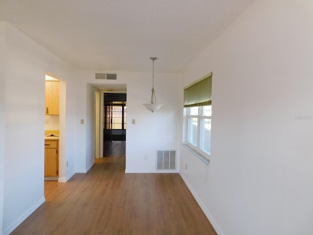 unfurnished room with hardwood / wood-style floors