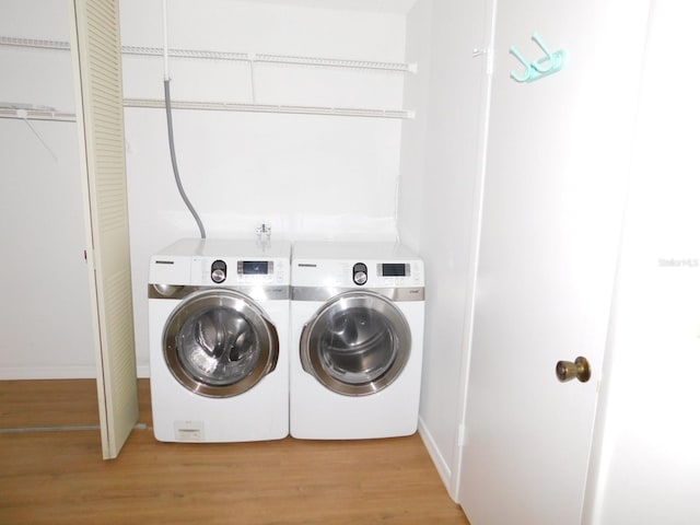 washroom featuring separate washer and dryer and light wood-type flooring