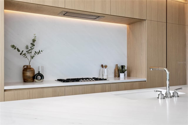 1000 Water St Unit 1402, Tampa, FL 33602 - kitchen view of a sink, modern cabinets, light countertops, and light brown cabinets