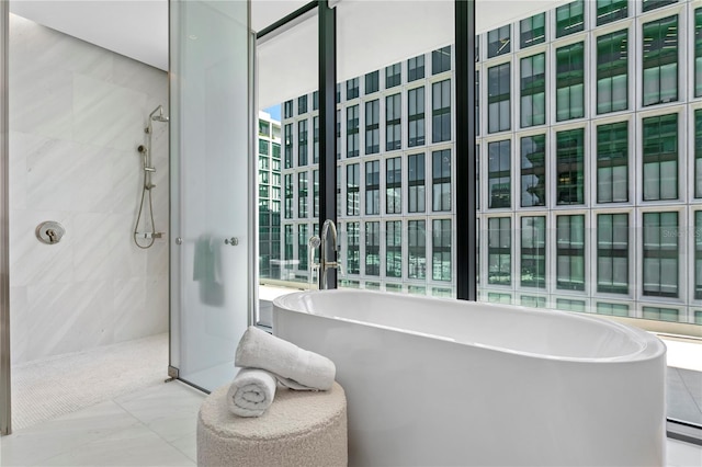 bathroom featuring a wealth of natural light and plus walk in shower