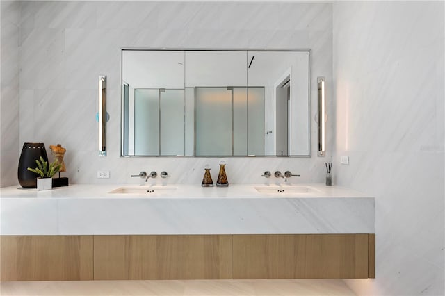 bathroom with vanity and tile walls