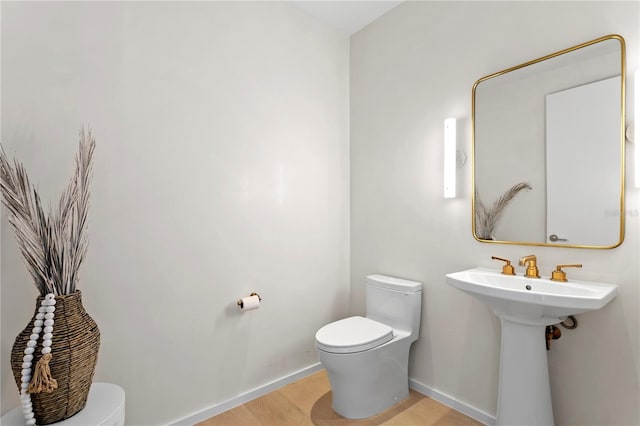 1000 Water St Unit 1402, Tampa, FL 33602 - half bathroom with toilet, wood finished floors, and baseboards