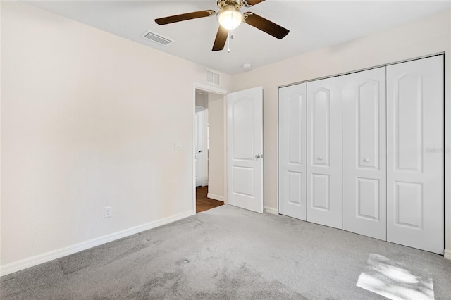 unfurnished bedroom featuring a closet, ceiling fan, and carpet floors