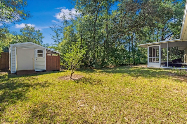 view of yard with a storage shed and a sunroom