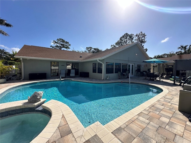 view of pool featuring an in ground hot tub and a patio