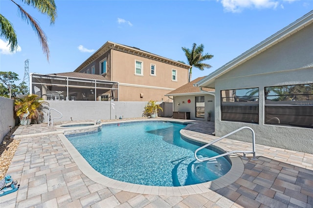 view of swimming pool with a lanai, a patio area, and an in ground hot tub