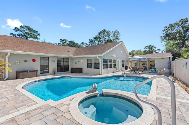 view of swimming pool with a patio area and an in ground hot tub