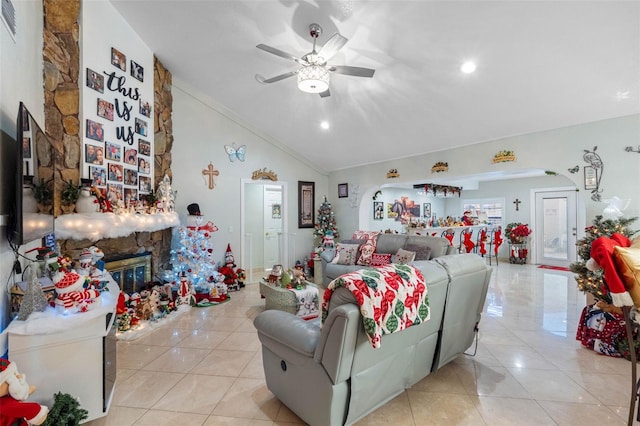 tiled living room featuring ceiling fan, a fireplace, and lofted ceiling