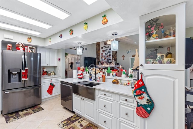 kitchen featuring white cabinetry, black dishwasher, stainless steel fridge with ice dispenser, pendant lighting, and light tile patterned floors