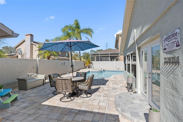 view of patio featuring a sunroom and a fenced in pool