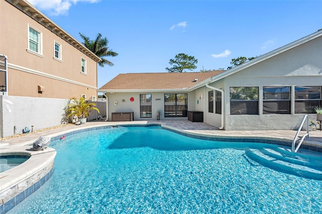 view of swimming pool featuring an in ground hot tub and a patio