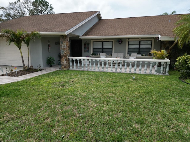 ranch-style home featuring stucco siding, a shingled roof, covered porch, an attached garage, and a front lawn