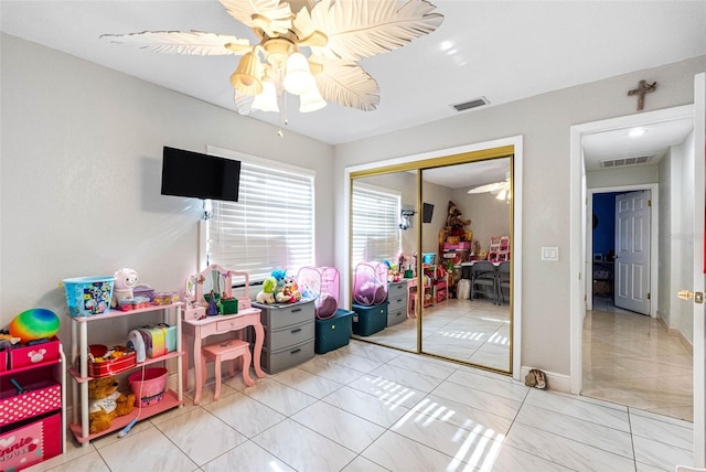 game room featuring tile patterned floors, visible vents, and a ceiling fan